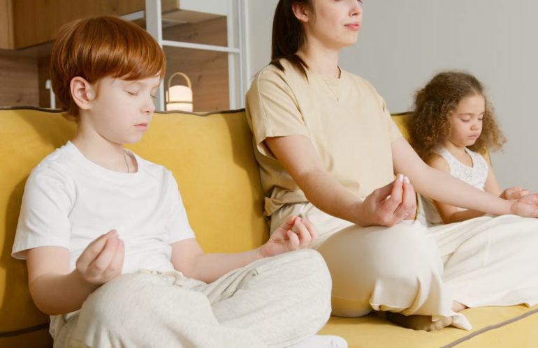 Family practicing meditation together on a couch, promoting mindfulness and relaxation.
